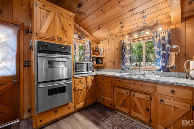 a kitchen with stainless steel appliances granite countertop a stove a sink and a refrigerator