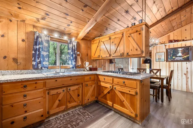 a kitchen with granite countertop sink and cabinets