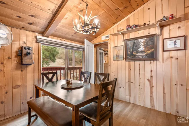 a view of a dining room with furniture wooden floor and a chandelier