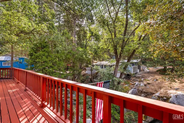 a view of balcony with wooden floor and fence