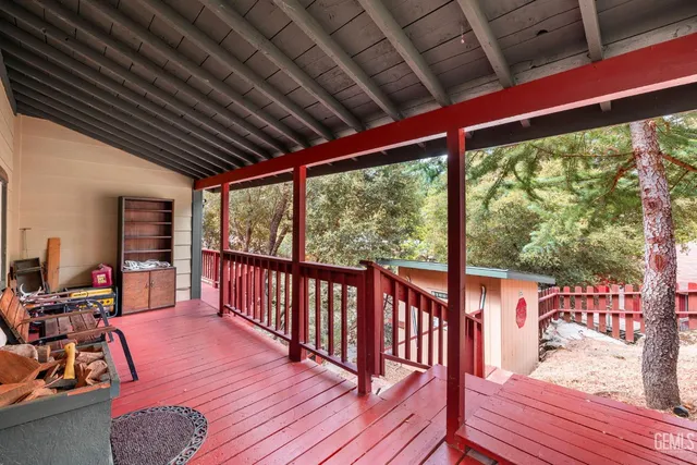 a view of a balcony with chairs and wooden floor
