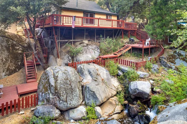 a view of a chairs and table in backyard