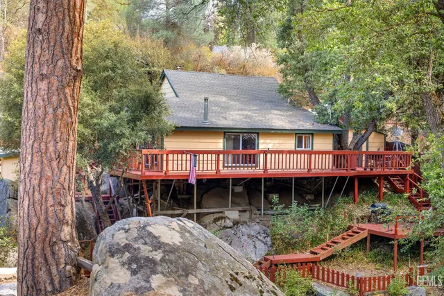 a front view of a house with balcony and garden