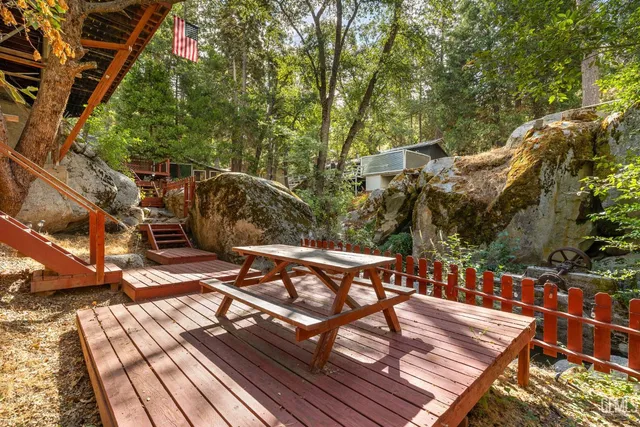 a view of a chairs and table on the wooden roof