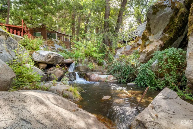 a backyard of a house with a yard and outdoor seating