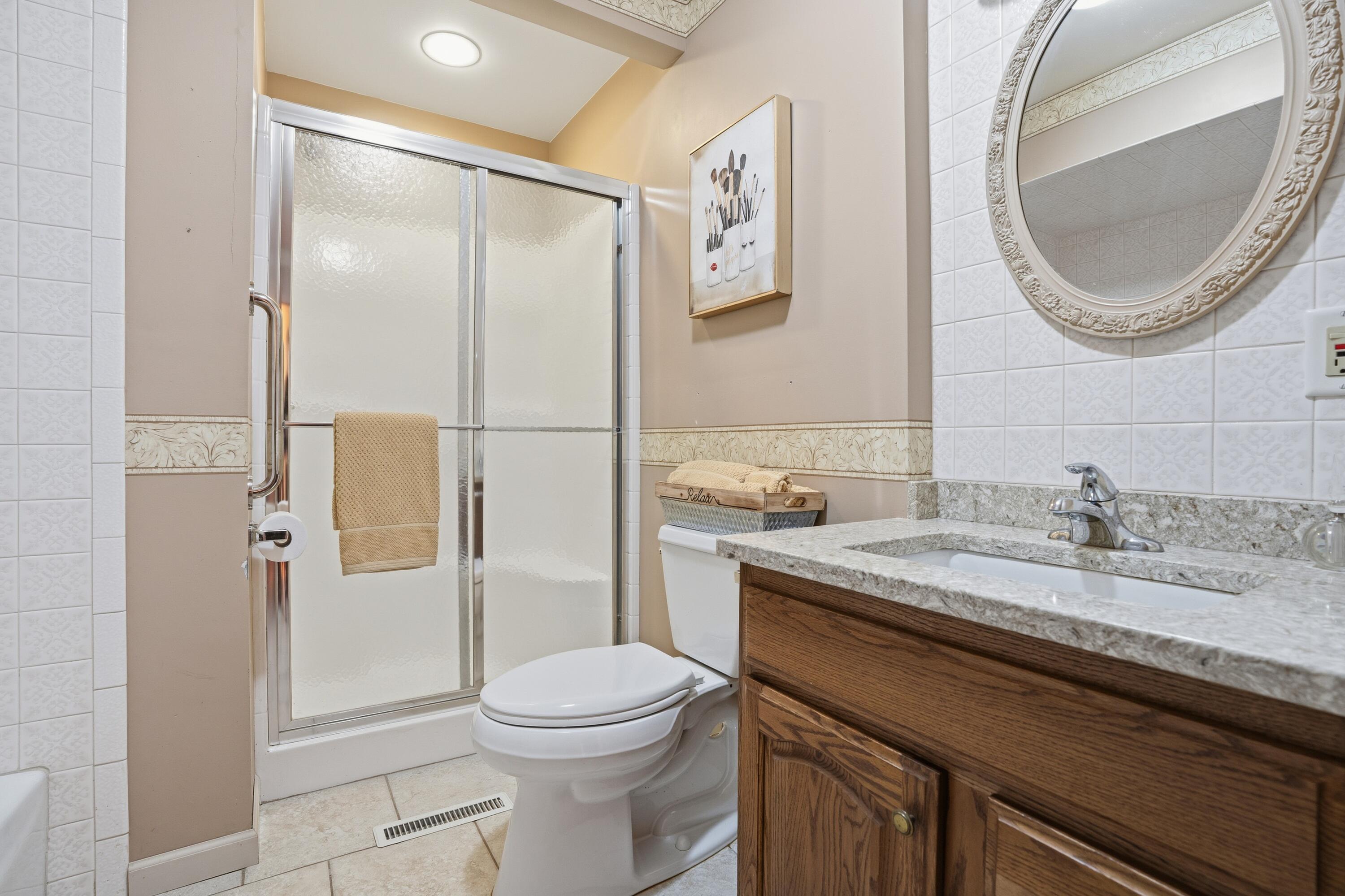 3514 41st Place Highland, IN 46322 - Photo 12 of 26 a bathroom with a granite countertop toilet sink and mirror