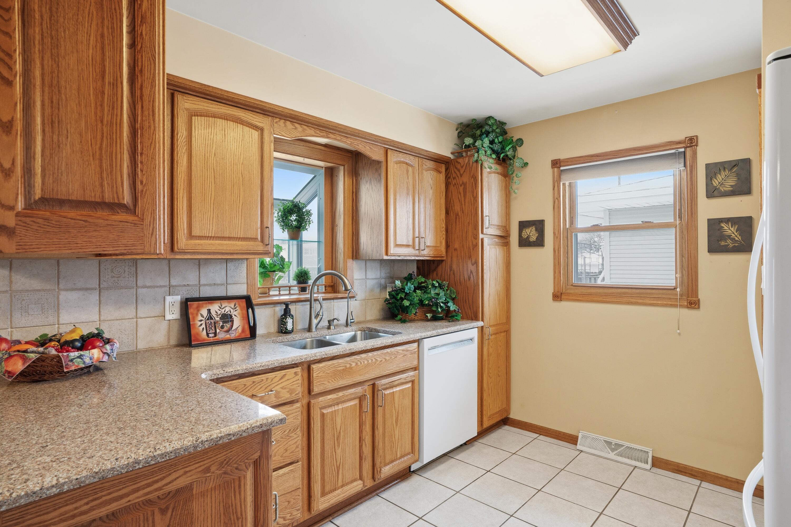 3514 41st Place Highland, IN 46322 - Photo 5 of 26 a kitchen with stainless steel appliances granite countertop white cabinets a refrigerator and a sink
