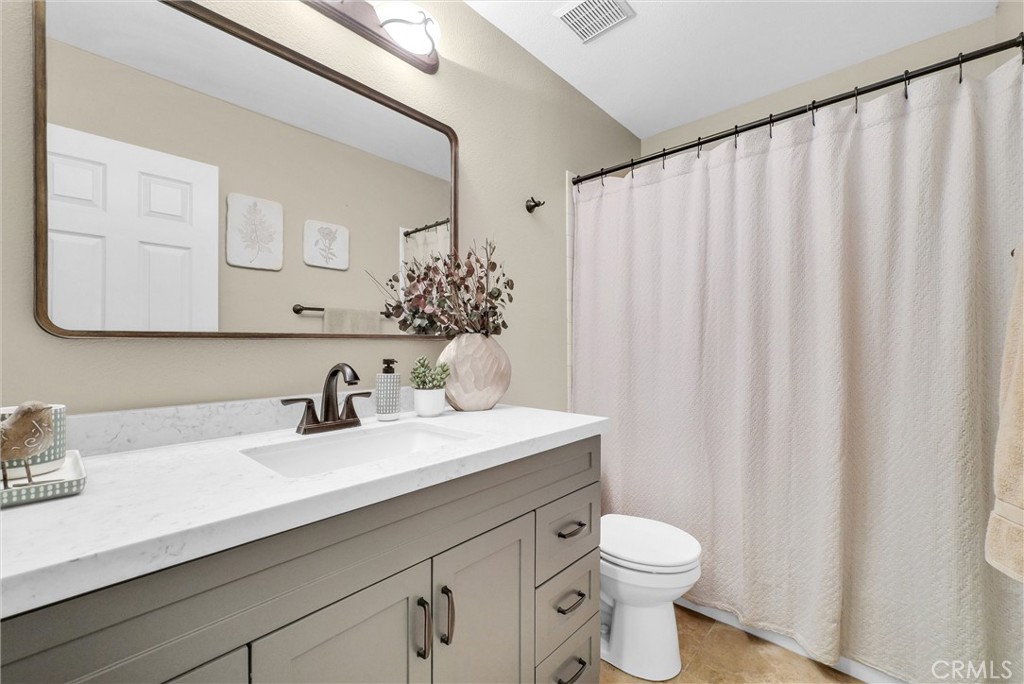17358 Cold Spring Circle Riverside, CA 92503 - Photo 13 of 34 a bathroom with a sink a toilet and a mirror