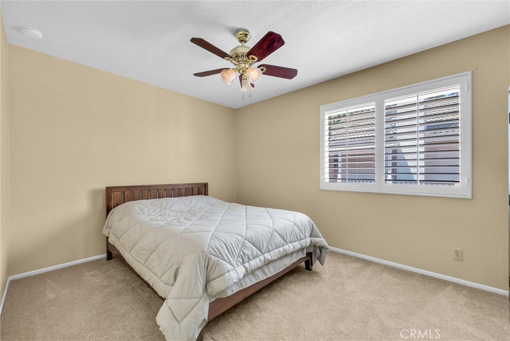 17358 Cold Spring Circle Riverside, CA 92503 - Photo 20 of 34 a bed sitting in a bedroom next to a window