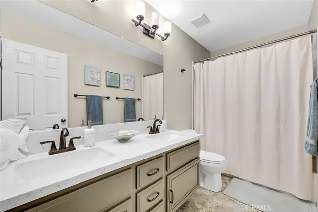 a bathroom with a double vanity sink and a mirror