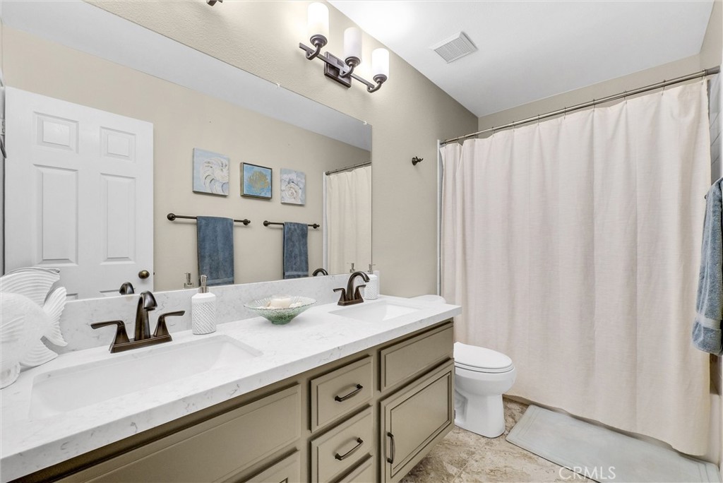 17358 Cold Spring Circle Riverside, CA 92503 - Photo 22 of 34 a bathroom with a double vanity sink and a mirror