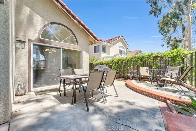 a view of a house with backyard porch and sitting area