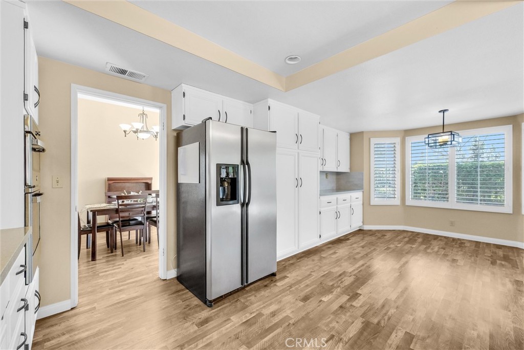 17358 Cold Spring Circle Riverside, CA 92503 - Photo 6 of 34 a kitchen with stainless steel appliances a refrigerator and wooden floor