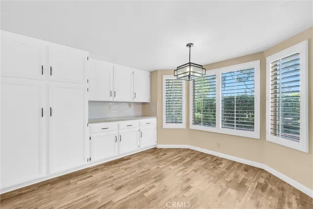 a kitchen with granite countertop a stove a sink and dishwasher with wooden floor