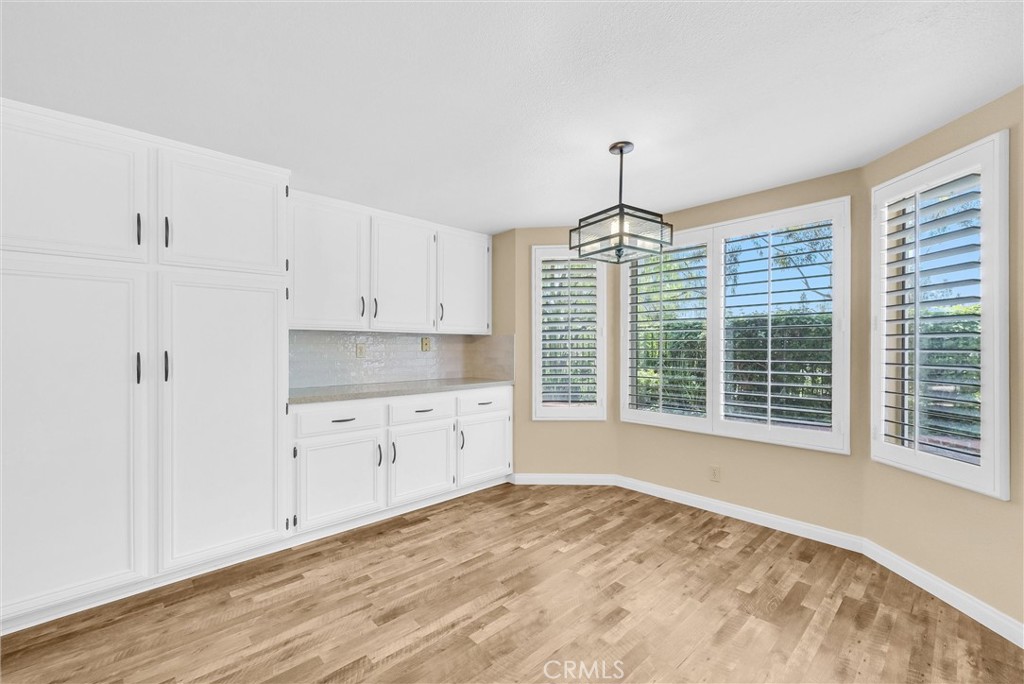 17358 Cold Spring Circle Riverside, CA 92503 - Photo 8 of 34 a kitchen with granite countertop a stove a sink and dishwasher with wooden floor