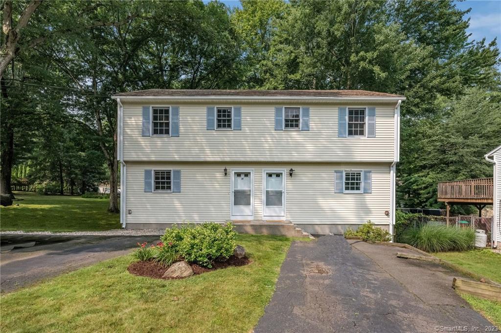 41 Case Street Farmington, CT 06032 - Photo 1 of 1 a front view of a house with a yard and garage