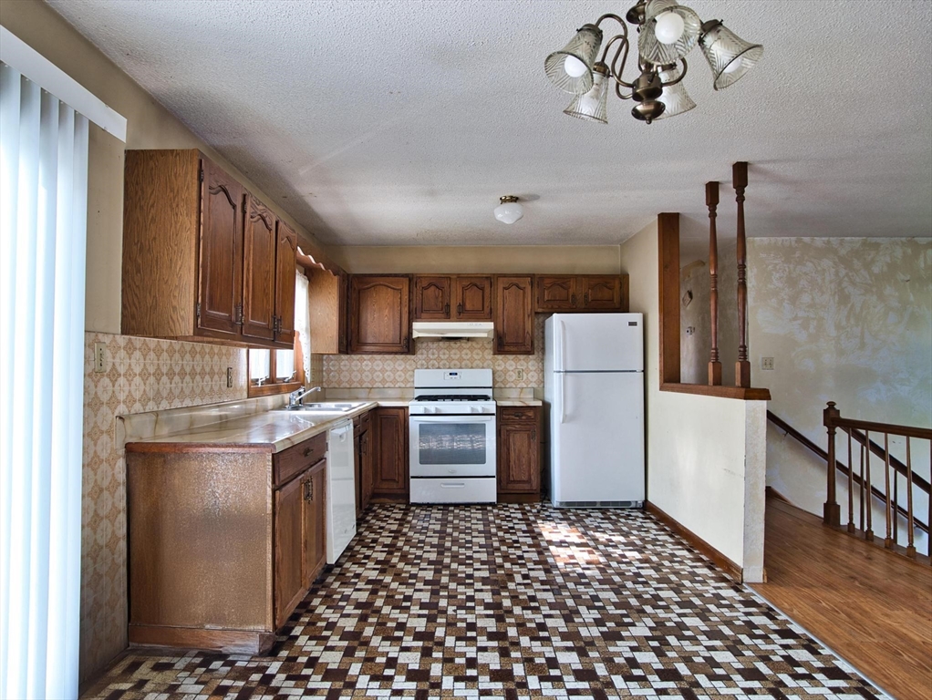 170 Nelson Street Fall River, MA 02721 - Photo 20 of 42 a kitchen with a refrigerator and a stove top oven