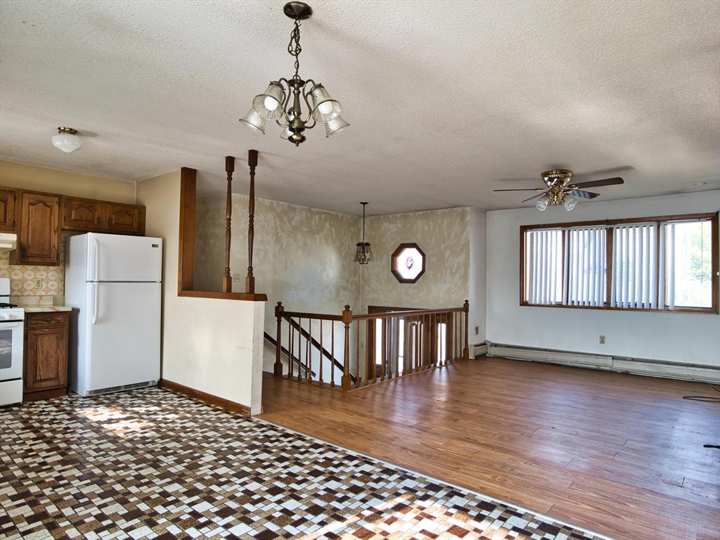 170 Nelson Street Fall River, MA 02721 - Photo 21 of 42 a view of a livingroom with furniture wooden floor a chandelier and windows