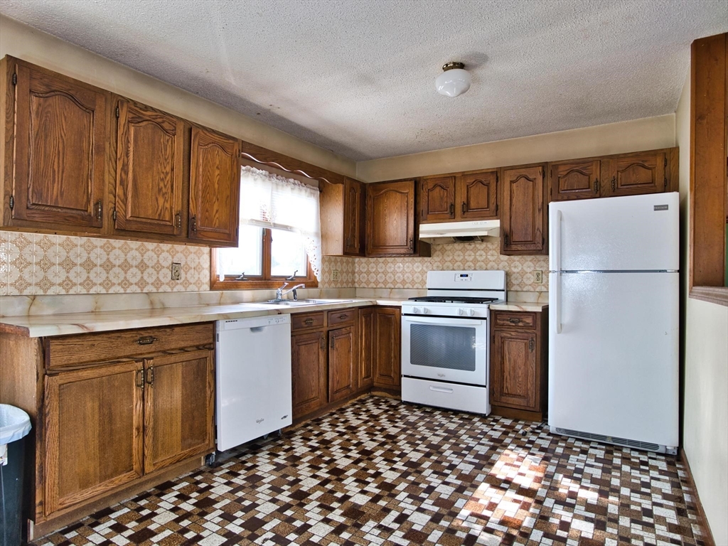 170 Nelson Street Fall River, MA 02721 - Photo 22 of 42 a kitchen with a refrigerator stove and sink