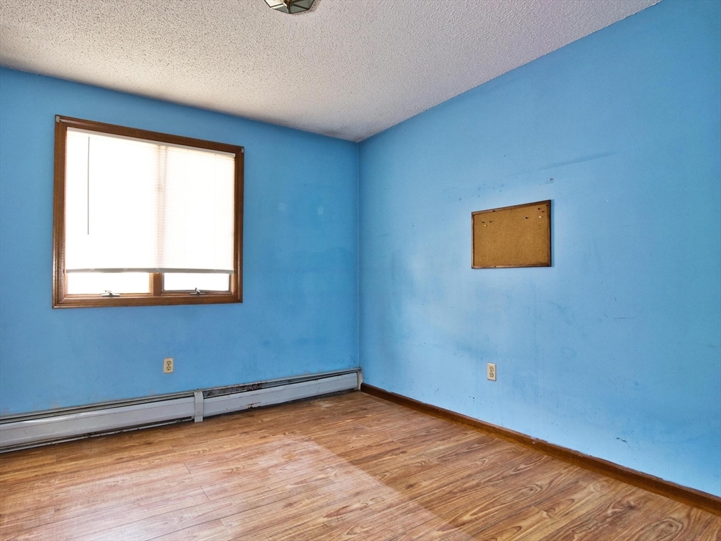 170 Nelson Street Fall River, MA 02721 - Photo 26 of 42 a view of an empty room with wooden floor and a window