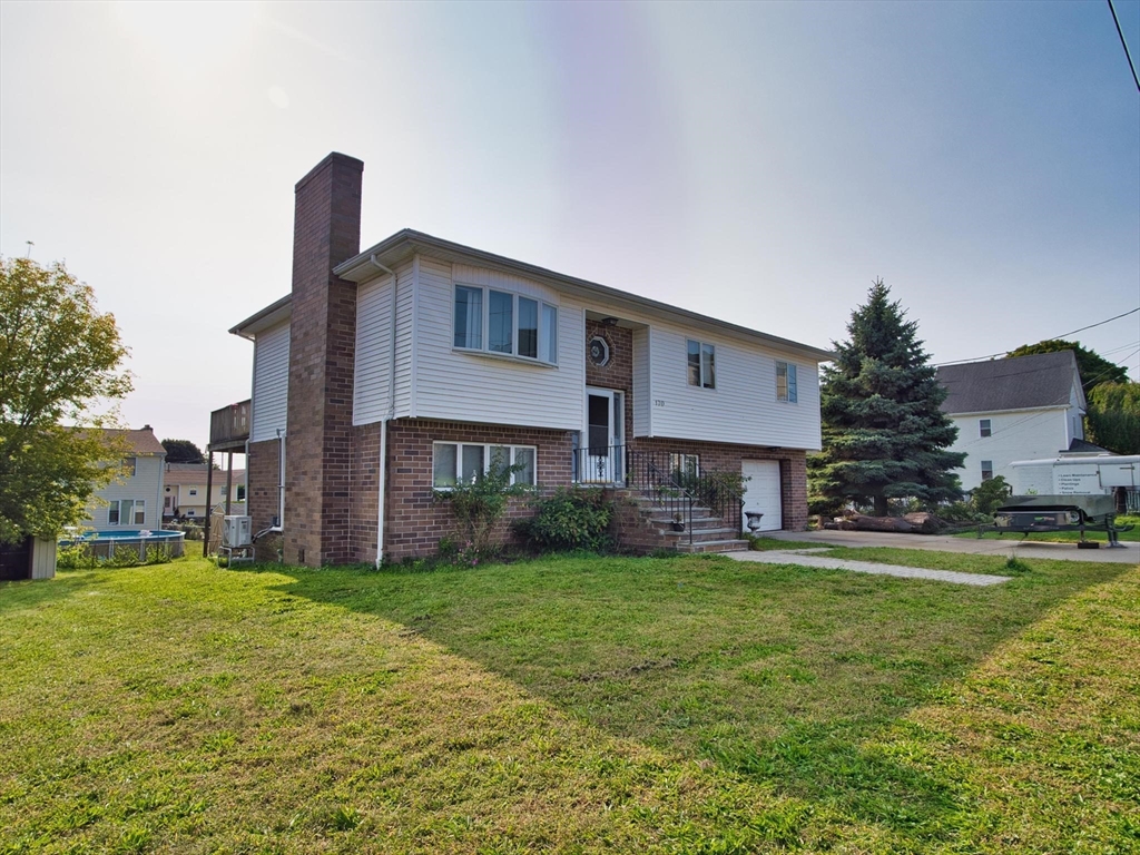 170 Nelson Street Fall River, MA 02721 - Photo 3 of 42 a house view with a sitting space and garden