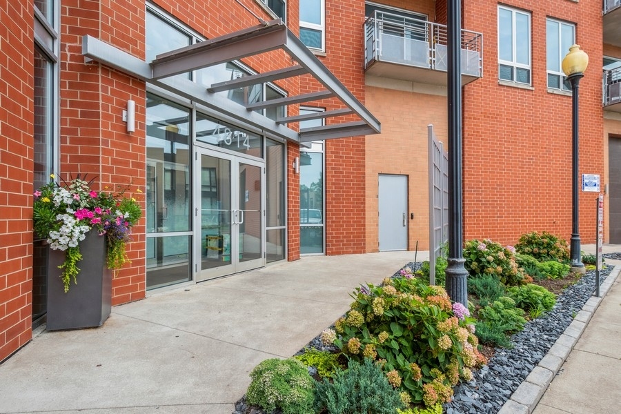 4814 North Clark Street, Unit 201 Chicago, IL 60640 - Photo 2 of 24 a front view of a building with a garden