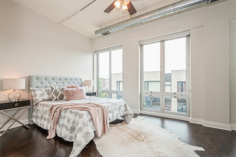 4814 North Clark Street, Unit 201 Chicago, IL 60640 - Photo 13 of 24 a bedroom with bed and a large window