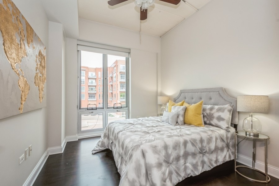 4814 North Clark Street, Unit 201 Chicago, IL 60640 - Photo 16 of 24 a bedroom with a large bed and a window