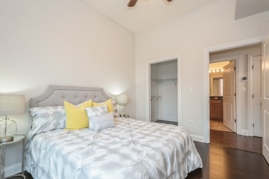 4814 North Clark Street, Unit 201 Chicago, IL 60640 - Photo 17 of 24 a bedroom with a bed and a night stand