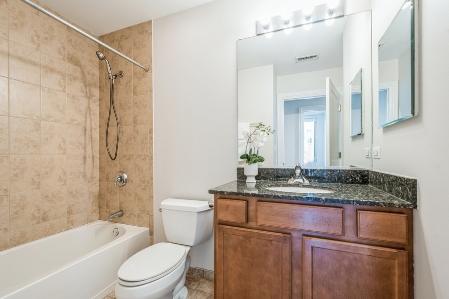 4814 North Clark Street, Unit 201 Chicago, IL 60640 - Photo 19 of 24 a bathroom with a granite countertop sink toilet and shower
