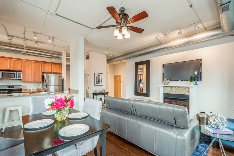 4814 North Clark Street, Unit 201 Chicago, IL 60640 - Photo 6 of 24 a living room with furniture kitchen and a chandelier