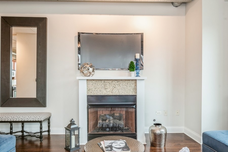 4814 North Clark Street, Unit 201 Chicago, IL 60640 - Photo 7 of 24 a living room with furniture and a fireplace