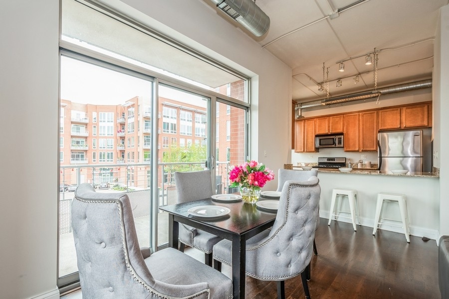 4814 North Clark Street, Unit 201 Chicago, IL 60640 - Photo 9 of 24 a dining room with furniture window and wooden floor