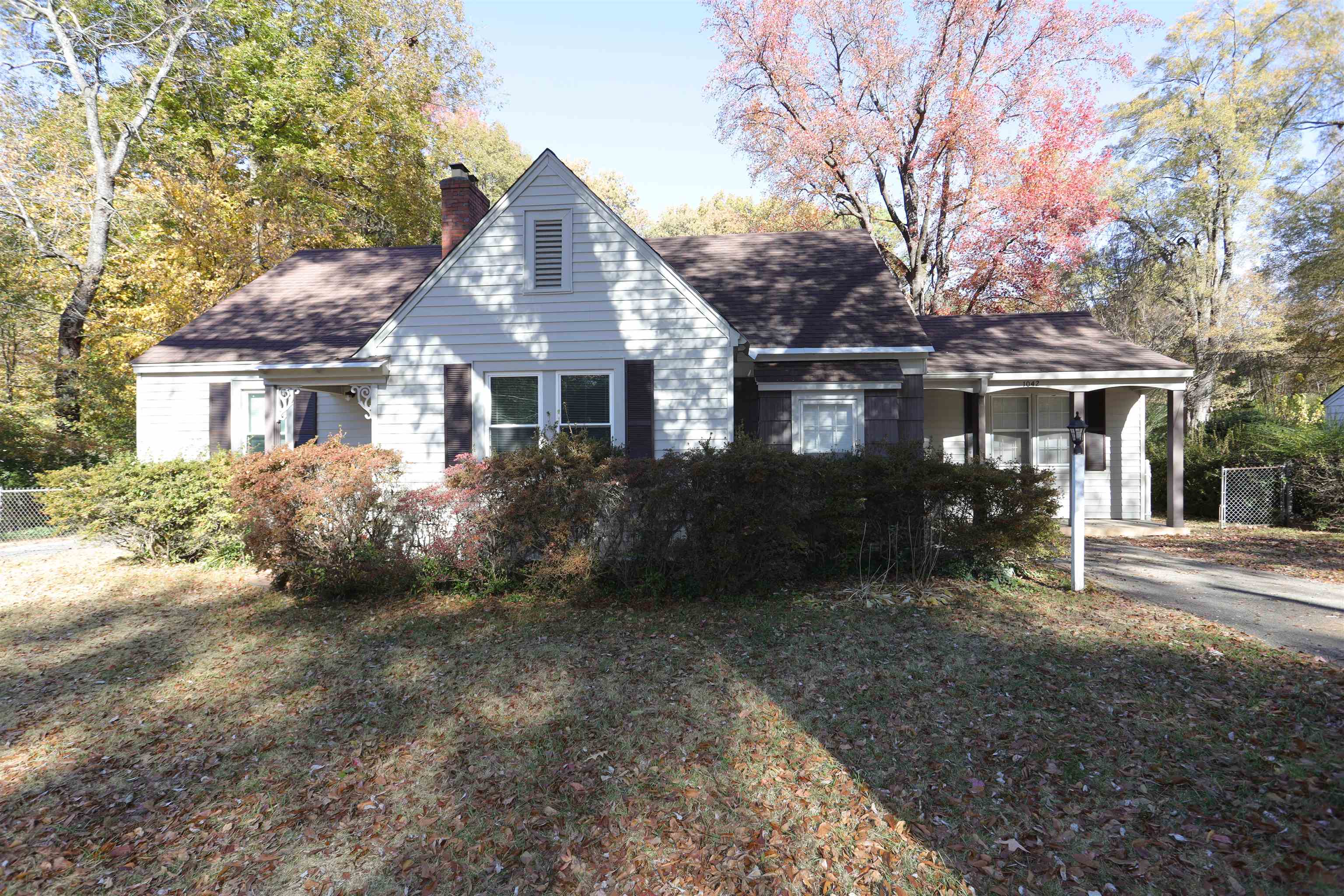 1042 Mosby Road Memphis, TN 38116 - Photo 1 of 21 a front view of a house with a garden and porch