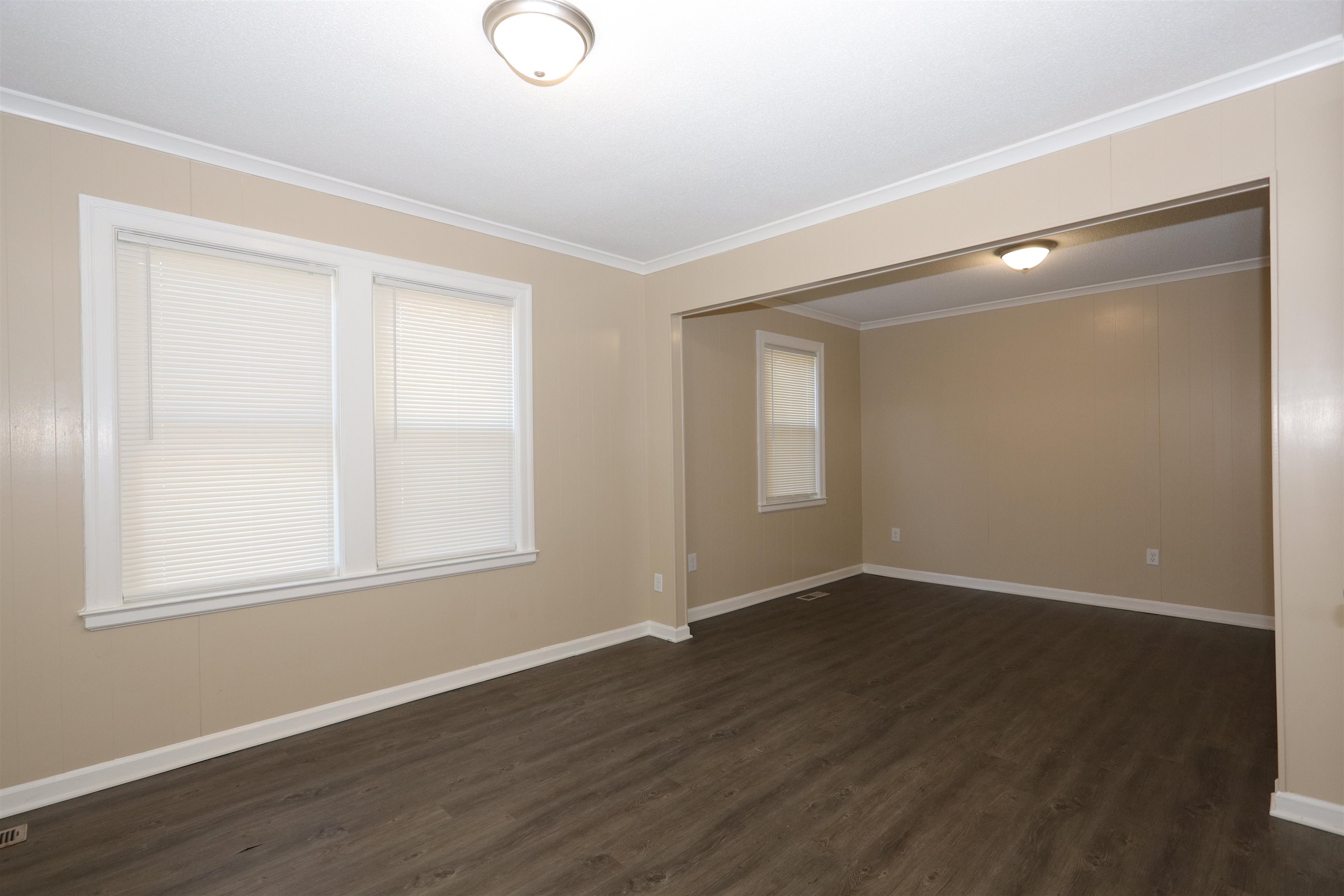 1042 Mosby Road Memphis, TN 38116 - Photo 11 of 21 a view of an empty room with wooden floor and a window