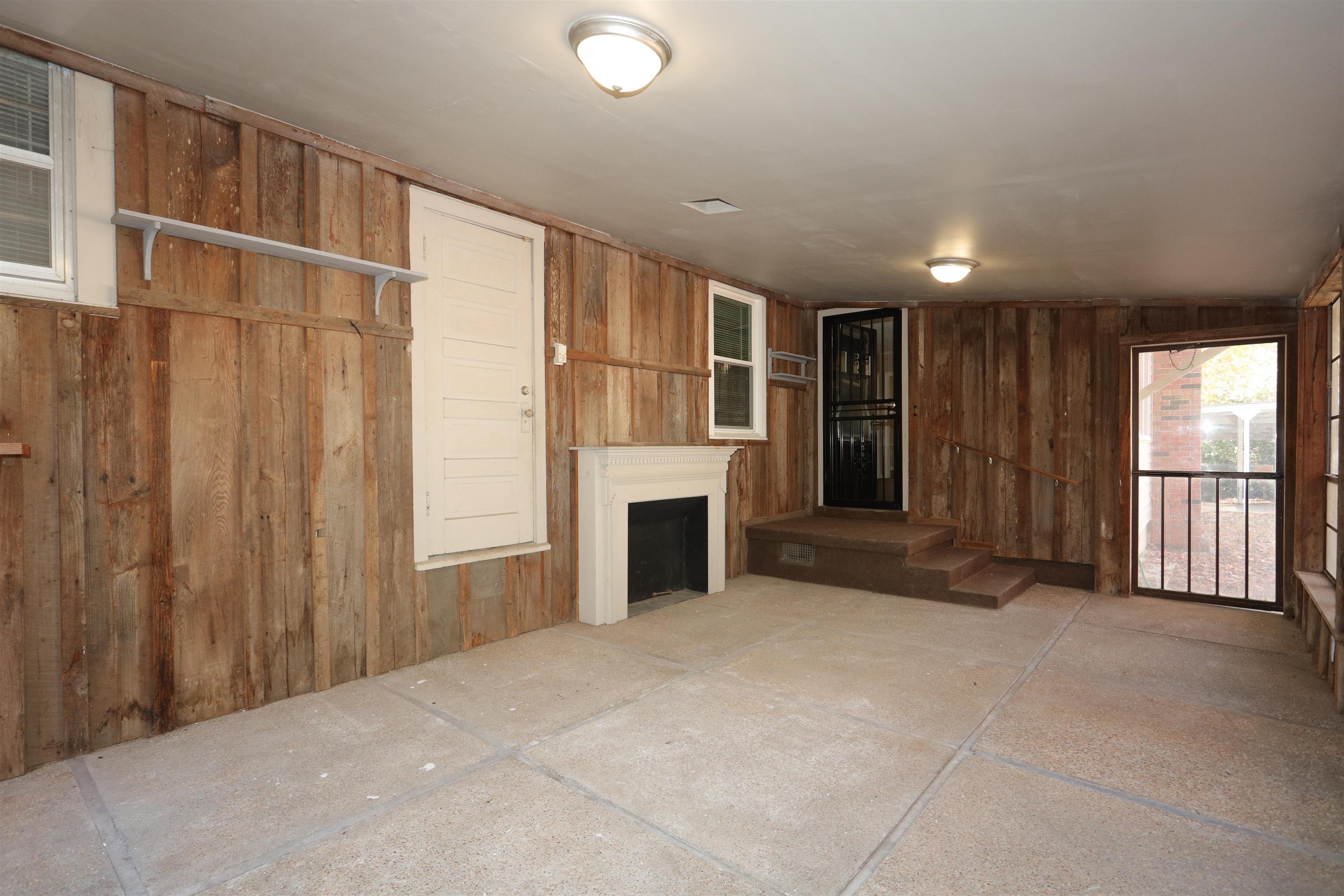 1042 Mosby Road Memphis, TN 38116 - Photo 16 of 21 a view of a livingroom with an empty space and a fireplace