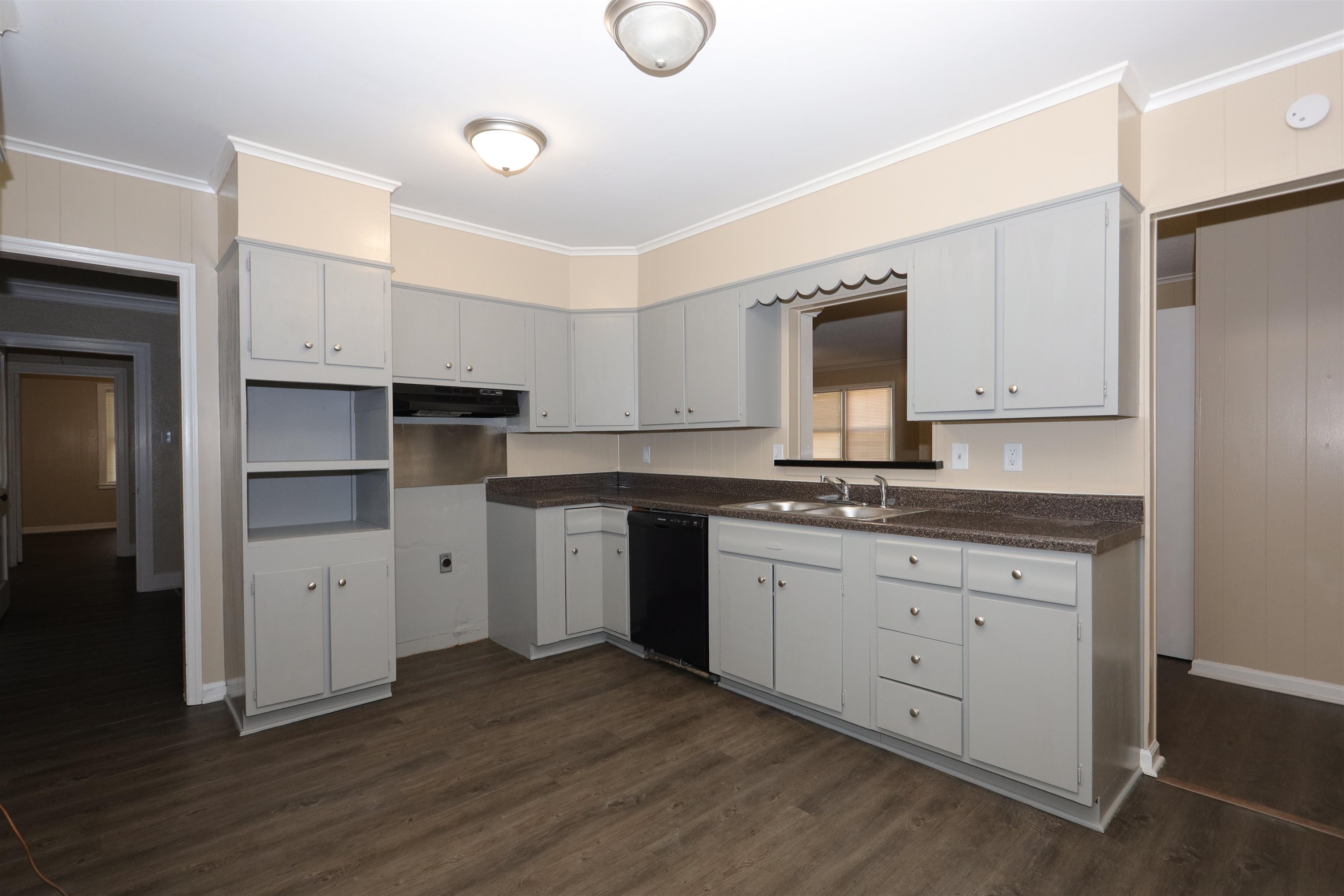 1042 Mosby Road Memphis, TN 38116 - Photo 17 of 21 a kitchen with sink cabinets and wooden floor
