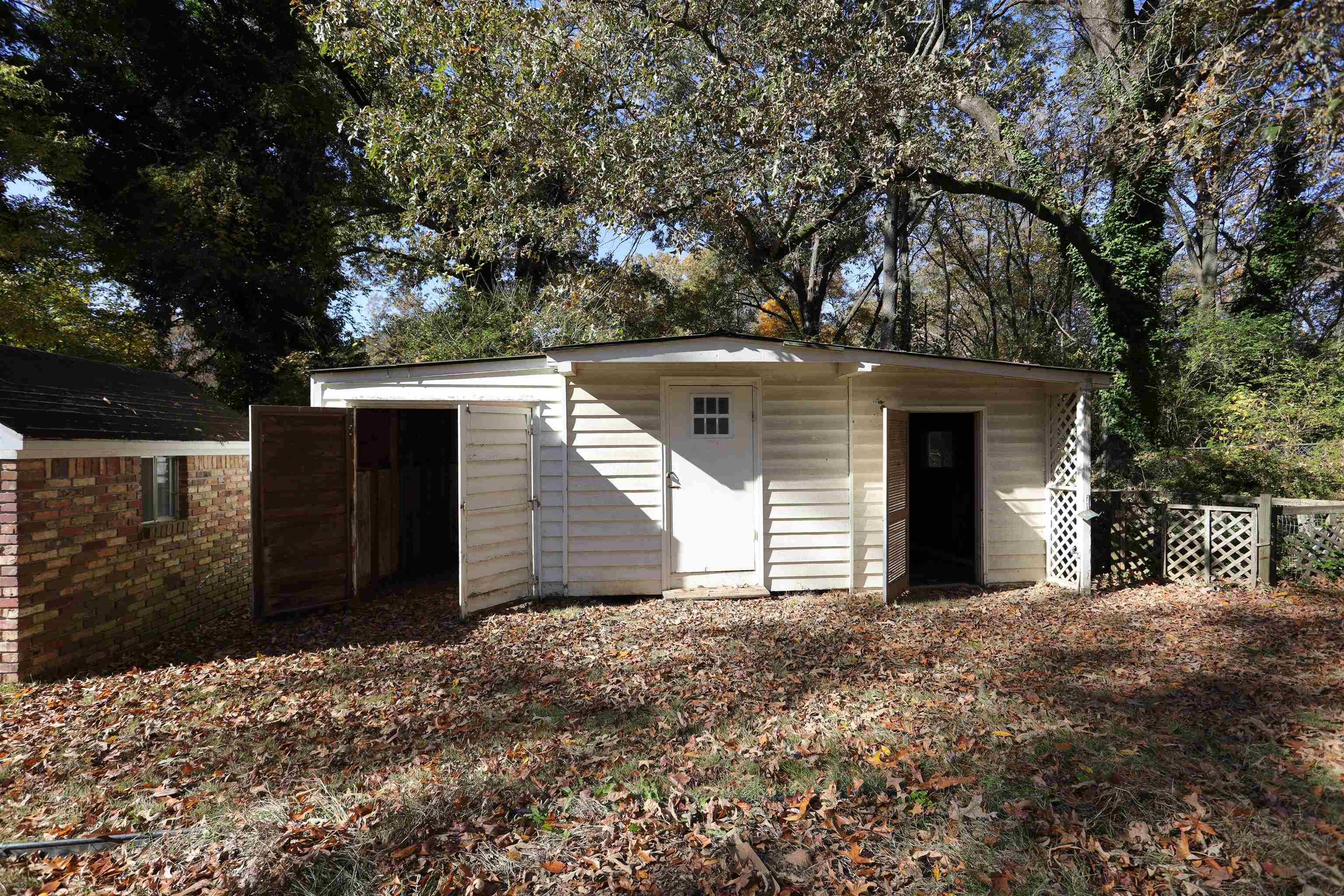 1042 Mosby Road Memphis, TN 38116 - Photo 6 of 21 a view of a house with a yard and garage
