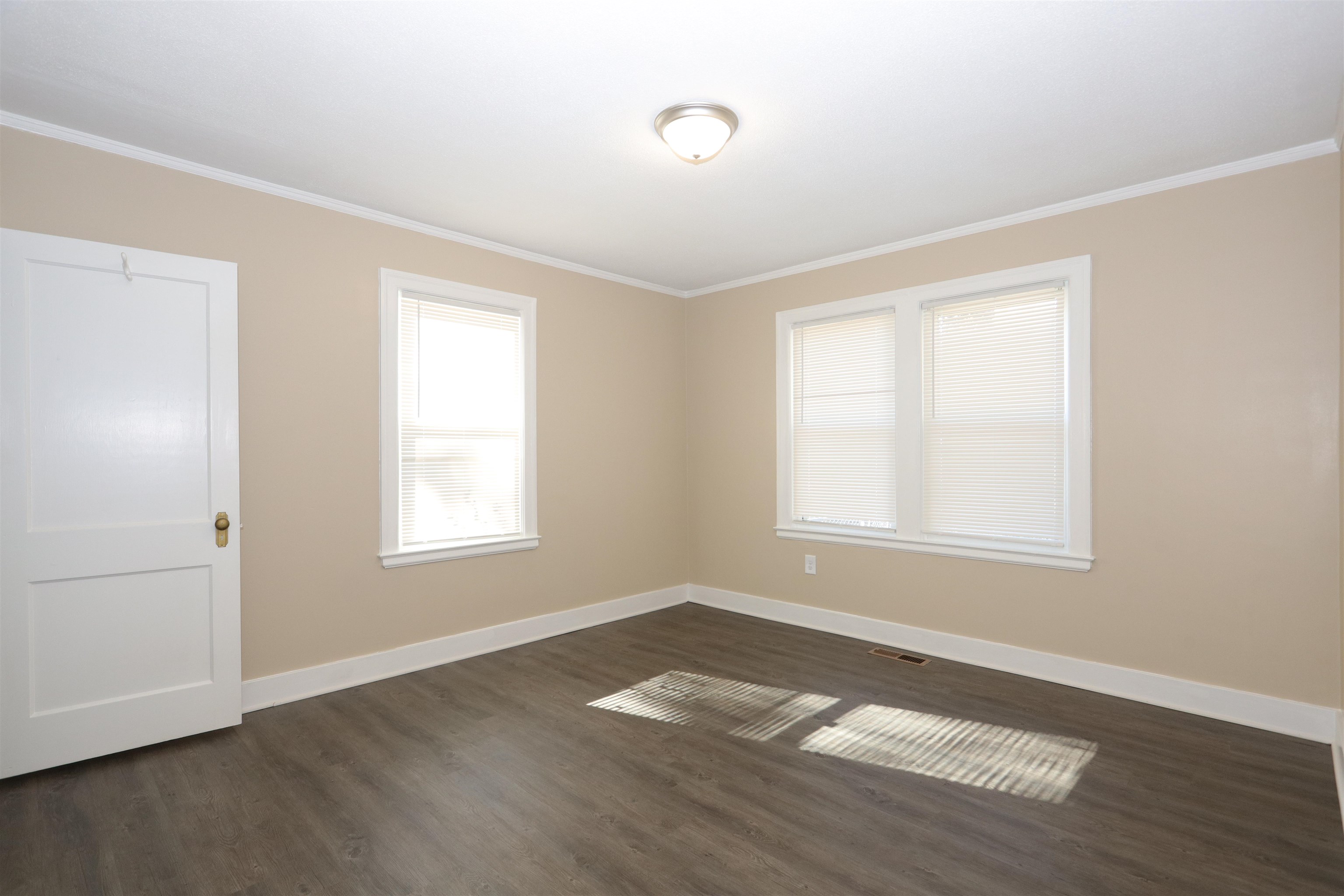 1042 Mosby Road Memphis, TN 38116 - Photo 10 of 21 a view of an empty room with wooden floor and a window