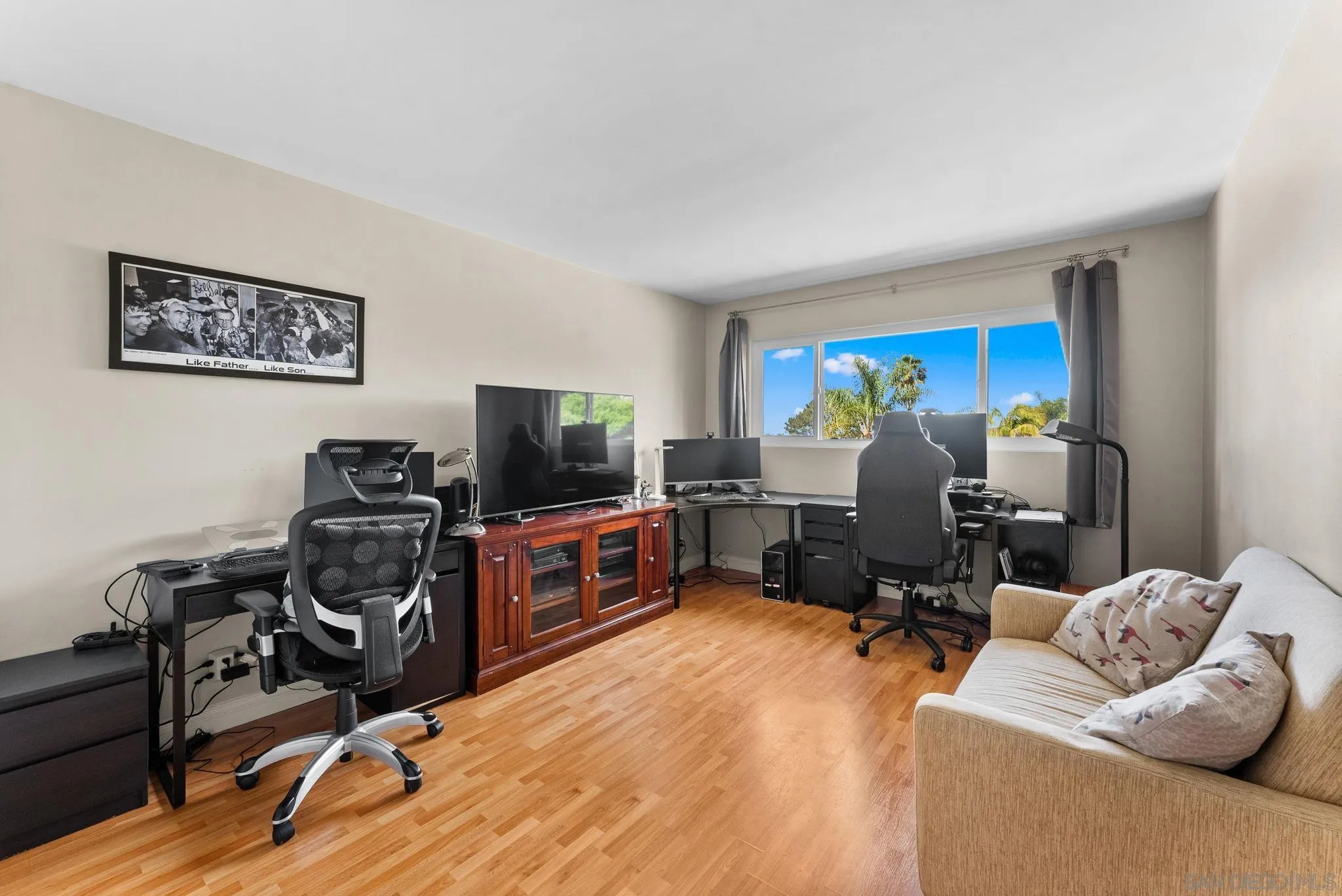 2360 Torrey Pines Road, Unit 28 La Jolla, CA 92037 - Photo 25 of 35 a bedroom with furniture and a flat screen tv
