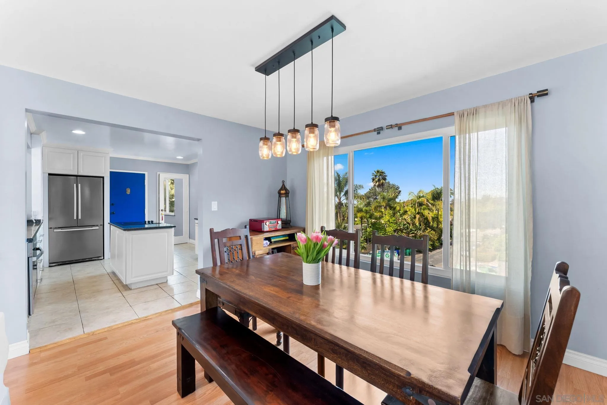 2360 Torrey Pines Road, Unit 28 La Jolla, CA 92037 - Photo 10 of 35 a view of a dining room with furniture a chandelier and wooden floor