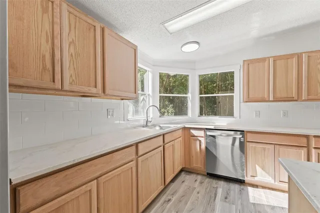 a kitchen with sink cabinets and window