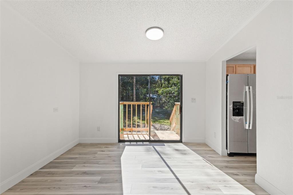 6718 West Pershing Drive Homosassa, FL 34448 - Photo 14 of 47 an empty room with wooden floor and windows