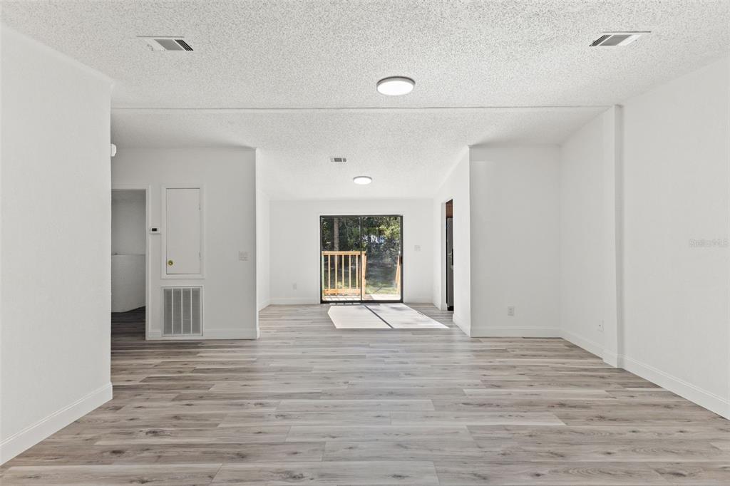 6718 West Pershing Drive Homosassa, FL 34448 - Photo 16 of 47 a view of an empty room with wooden floor and a window