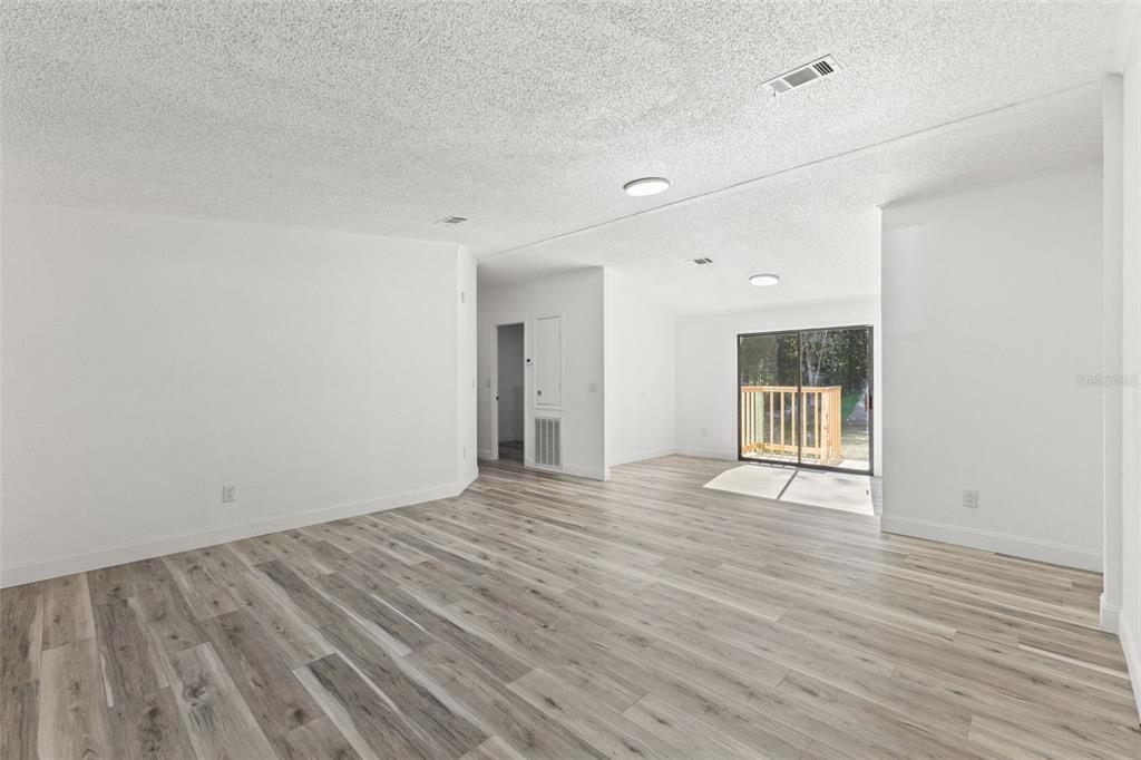 6718 West Pershing Drive Homosassa, FL 34448 - Photo 17 of 47 a view of an empty room with wooden floor and a window