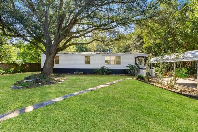 a view of house with backyard