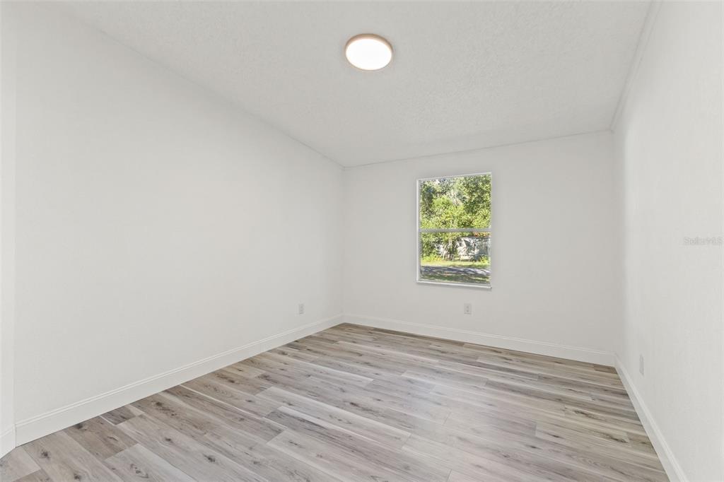 6718 West Pershing Drive Homosassa, FL 34448 - Photo 30 of 47 wooden floor in an empty room with a window