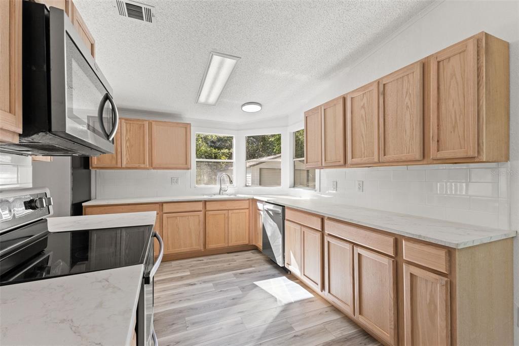 6718 West Pershing Drive Homosassa, FL 34448 - Photo 7 of 47 a kitchen with stainless steel appliances granite countertop a sink and cabinets