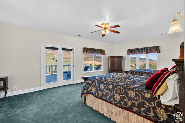 4768 East Hickman Canyon Road Stockton, UT 84071 - Photo 28 of 85 Large second floor bedroom with access to west balcony, carpet, french doors, and ceiling fan.