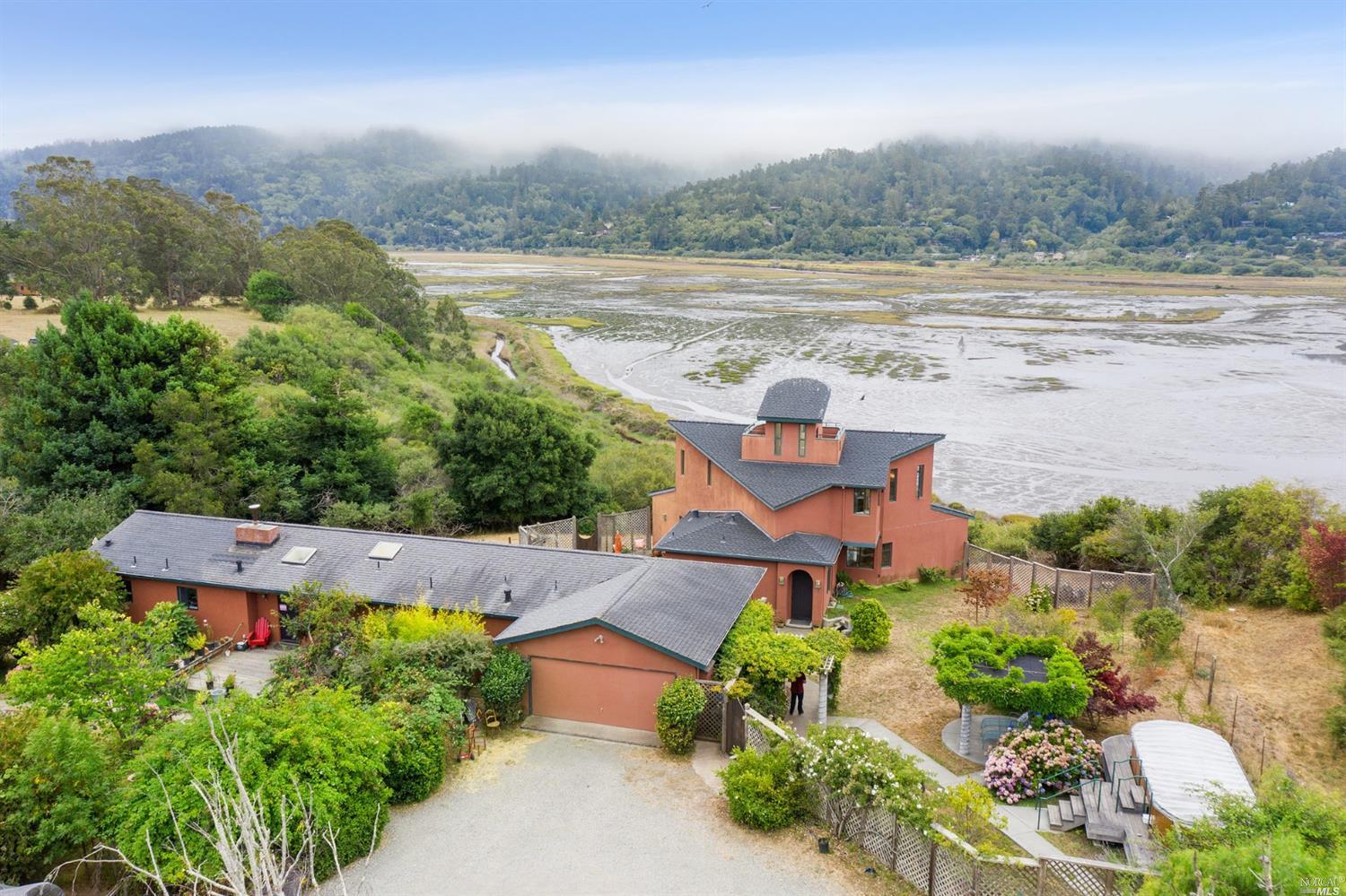 an aerial view of a house with a lake view